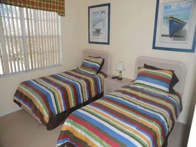 two beds sitting next to each other in a bedroom at Tranquil Waters Haven by Paradise Resort Vacations in Kissimmee
