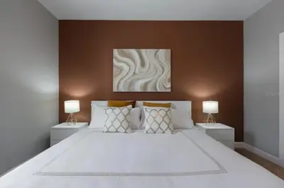 a bedroom with a large white bed with two lamps at 4 Bedrooms 3 Bathrooms Lucaya Village 2-101 in Kissimmee