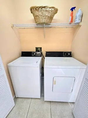 a laundry room with a washer and dryer at Retro 3 Bedroom Economy Family Home with washer and dryer in unit in Kissimmee