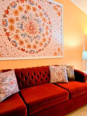 a red couch with pillows in a living room at Retro 3 Bedroom Economy Family Home with washer and dryer in unit in Kissimmee