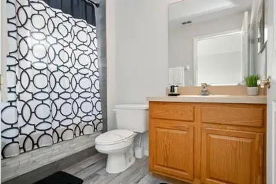 a bathroom with a toilet and a shower curtain at Casa 3 Quartos no Lake Berkley Resort in Kissimmee