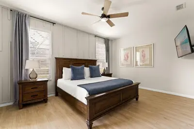 a bedroom with a bed and a ceiling fan at Tiki Palms Play and Pool Near Disney in Kissimmee