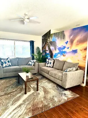 a living room with a couch and a table at Tropical Paradise in Orlando