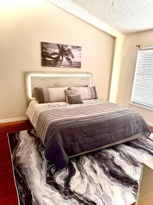 a bedroom with a large bed with a rug at Tropical Paradise in Orlando