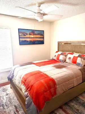 a bedroom with a bed and a ceiling fan at Tropical Paradise in Orlando
