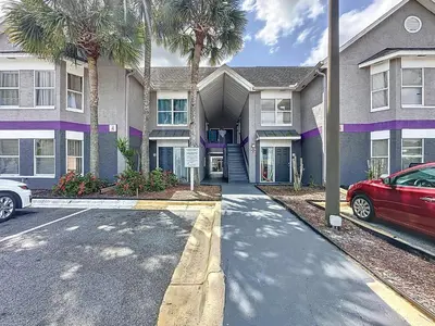 a house with a car parked in front of it at Two bed condo in Parkway Palms Resort in Orlando
