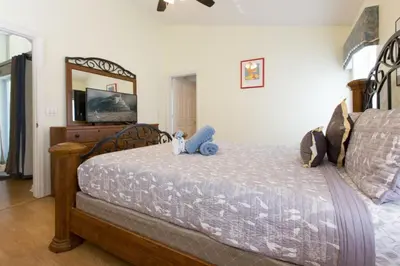 a bedroom with a bed with two stuffed animals on it at Indian Creek Vacation Home Close to Disney in Orlando