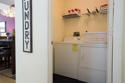 a kitchen with a washer and dryer in a room at Indian Creek Vacation Home Close to Disney in Orlando