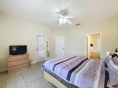 a bedroom with a bed and a ceiling fan at Walk to Silver Spurs Rodeo and Heritage Park in Kissimmee