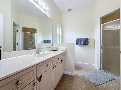 a bathroom with a sink and a large mirror at Walk to Silver Spurs Rodeo and Heritage Park in Kissimmee