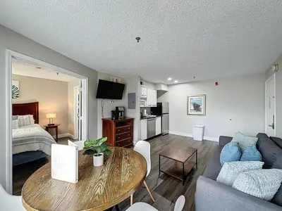 a living room with a couch and a table in a room at Parkway Palms Resort 1 bed condo mins to Disney. in Orlando