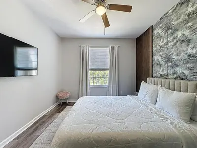 a bedroom with a bed and a ceiling fan at Beautiful Three bed condo, Minutes from Disney in Kissimmee