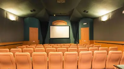 an empty auditorium with a screen in a theatre at Beautiful Three bed condo, Minutes from Disney in Kissimmee
