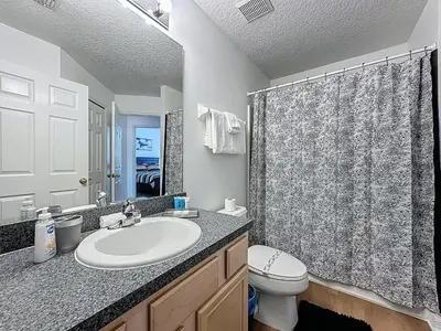 a bathroom with a sink and a toilet and a shower at Emerald Island 4Bd/3Ba Villa, 3 miles to Disney in Kissimmee