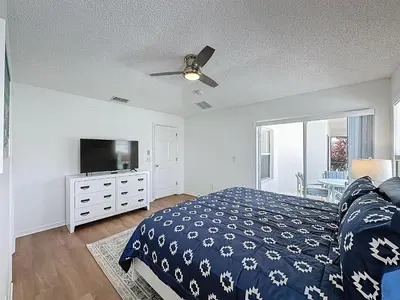 a bedroom with a bed and a flat screen tv at Emerald Island 4Bd/3Ba Villa, 3 miles to Disney in Kissimmee