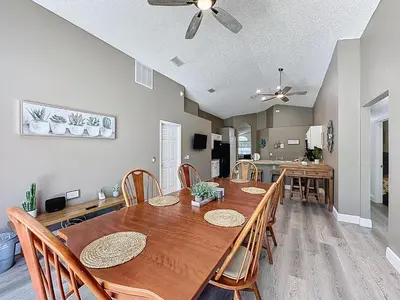 a dining room with a wooden table and chairs at Terra Verde Resort 4 Bed Pool/Spa Villa in Kissimmee