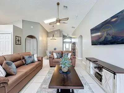 a living room with a couch and a table at Casa del Sol at Indian Creek Four Corners in Kissimmee