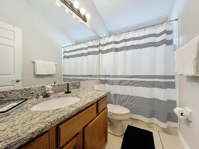 a bathroom with a sink and a toilet and a shower at Casa del Sol at Indian Creek Four Corners in Kissimmee