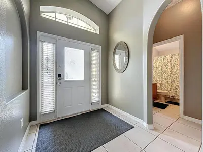 a hallway with a door and a window and a mirror at Casa del Sol at Indian Creek Four Corners in Kissimmee