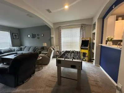 a living room with a foosball table in the middle at Emerald Island Resort 6 Bed Pool & Spa in Kissimmee