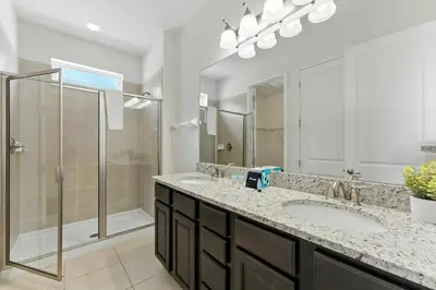 a bathroom with two sinks and a shower at 7416 Encore Reunion poolspa 11 guests 5 bdrs BBQ in Orlando
