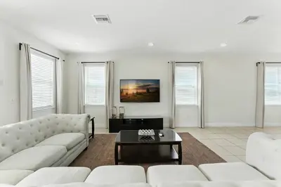 a living room with a white couch and a table at 7416 Encore Reunion poolspa 11 guests 5 bdrs BBQ in Orlando