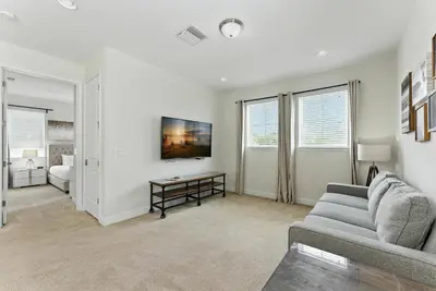 a living room with a couch and a table at 7416 Encore Reunion poolspa 11 guests 5 bdrs BBQ in Orlando