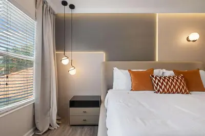 a bedroom with a bed with pillows and a window at 2540HS 6Bedrooms Disney Villa Sleeps 20 with Pool & Spa in Orlando