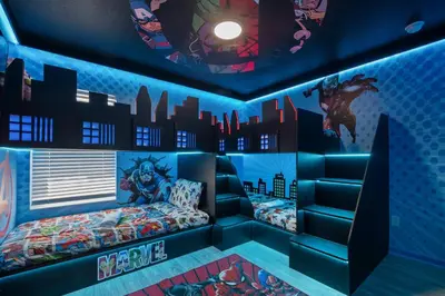 a room with a bed with a superhero mural at 2540HS 6Bedrooms Disney Villa Sleeps 20 with Pool & Spa in Orlando