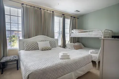 a bedroom with two beds and a bunk bed at Vista Cay Townhome Near Universal & Disney in Orlando