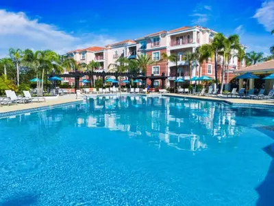 a swimming pool at a resort with blue water at Vista Cay Townhome Near Universal & Disney in Orlando