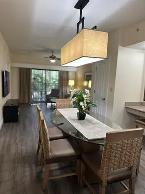 a dining room with a glass table and chairs at Central Location to all Parks and Convention center in Orlando