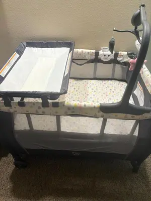 a baby crib with a suitcase on top of it at Central Location to all Parks and Convention center in Orlando