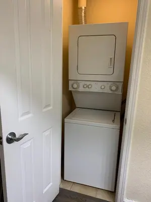 a microwave sitting on top of a washer and dryer at Central Location to all Parks and Convention center in Orlando