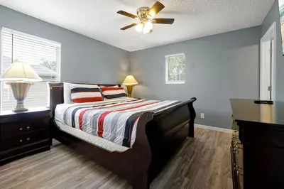 a bedroom with a bed and a ceiling fan at Ever After Estate in Kissimmee