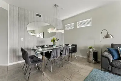 a dining room with a table and chairs at Storey Lake condos by Une Homes in Kissimmee