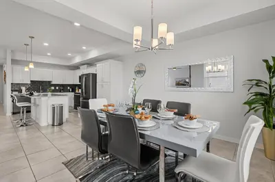a dining room and kitchen with a table and chairs at Storey Lake condos by Une Homes in Kissimmee