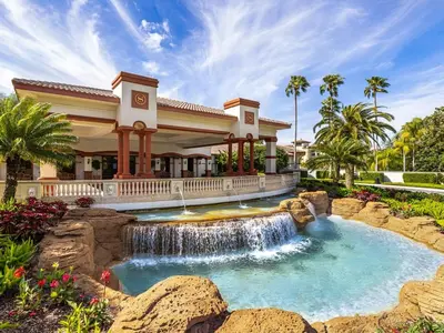 a waterfall in front of a house with a fountain at Sheraton Vistana Villages 1BR Apartment with Resort Access in Orlando