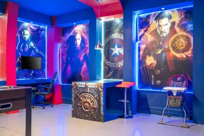 a room with a marvel themed room with a table and chairs at Stunning Mansion 15 ensuites in Kissimmee