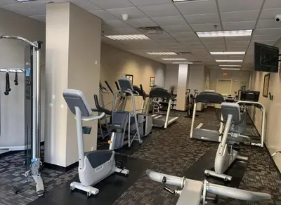 a gym with several rows of exercise bikes and treadmills at Resort Lake Buena Vista - 2 Quartos in Orlando