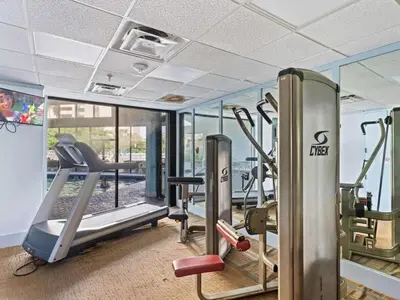 a gym with treadmills and elliptical machines at Apartamento Aconchegante no Enclave Suites in Orlando