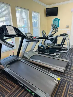 a gym with two treadmills and a treadmill at The Orlando Hideaway Family Townhome Steps from Disney 3BR 3BA in Kissimmee
