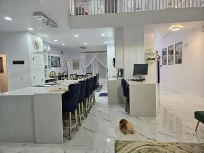a dog sitting on the floor in a room with a kitchen at Charming, beautiful house closer to Disney World in Orlando