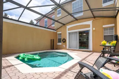 a swimming pool in the backyard of a house at Bright 3B w Pool Close to Disney Encantada 8545 in Kissimmee
