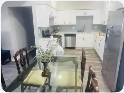 a kitchen with a glass table and a refrigerator at Entire 5 Bedroom Home in Winter Park FL in Orlando