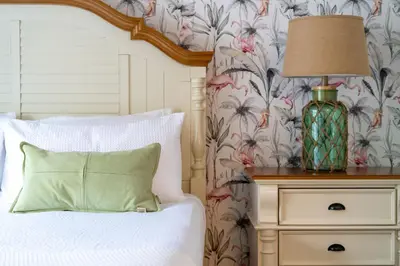 a bedroom with a bed with a lamp on a dresser at Magical Stay Near Disney I Pool and Resort Access in Kissimmee