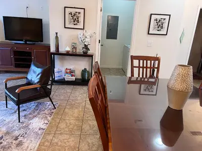 a living room with a tv and chairs at Toy Story Getaway Retreat in Kissimmee