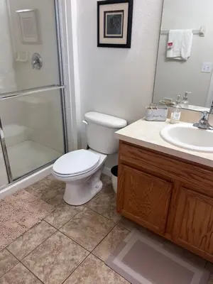 a bathroom with a toilet and a shower and a sink at Toy Story Getaway Retreat in Kissimmee