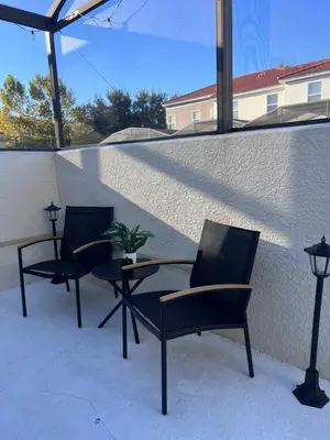 two chairs and a table on a patio at Toy Story Getaway Retreat in Kissimmee