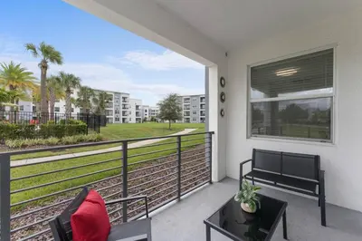 a balcony with a bench and a table and a view at 3120-102 Resort Pool View Disney Universal Orlando in Kissimmee